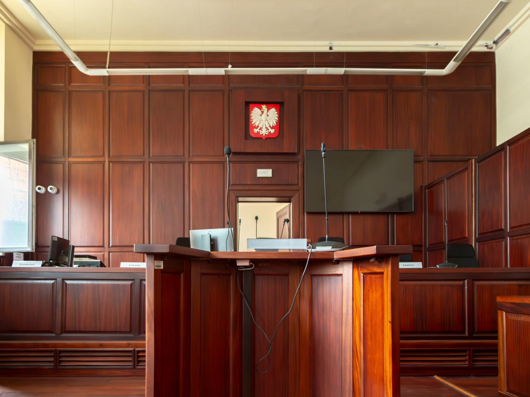 Elegant wooden interior of a courtroom in Wrocław, showcasing judicial decor.