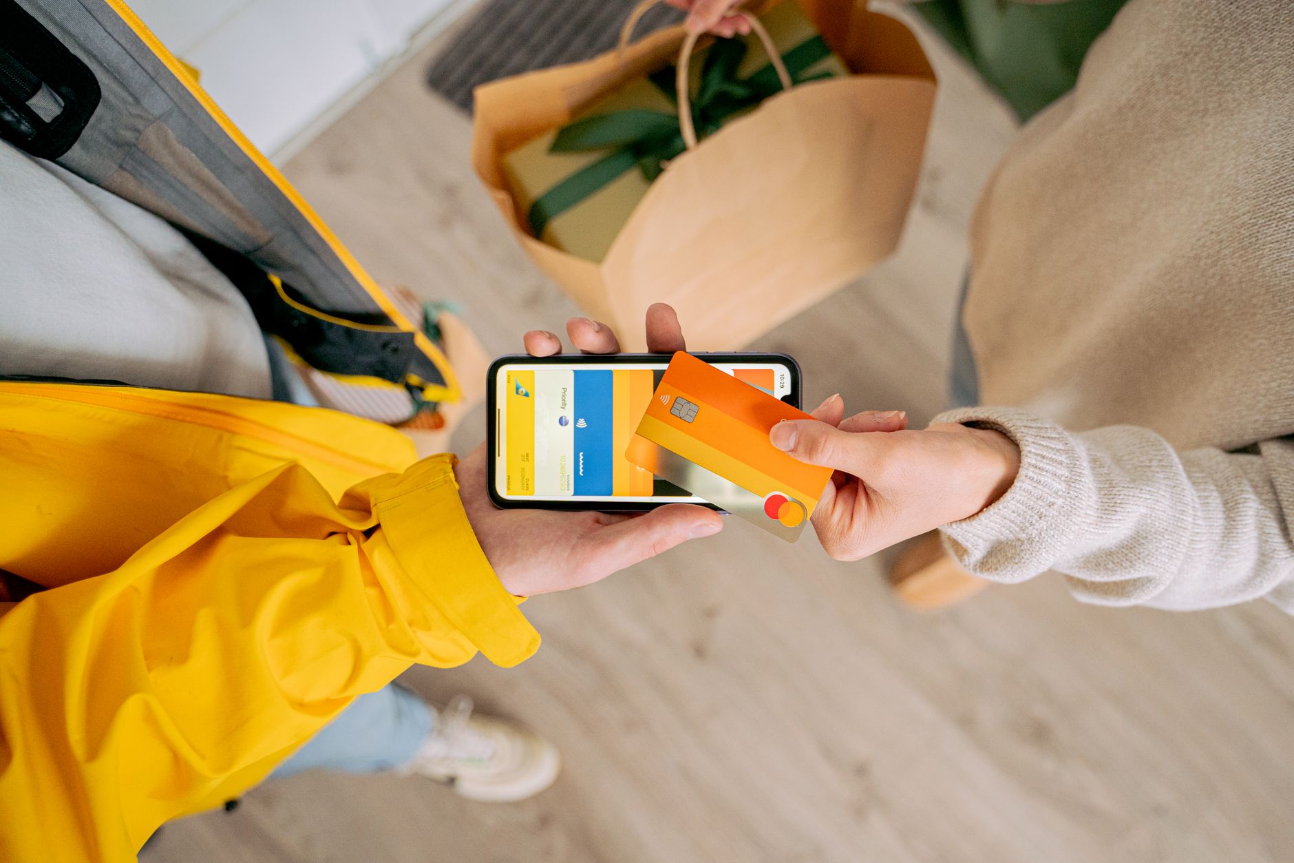 Person making contactless payment with a credit card using smartphone. Online shopping and delivery concept.