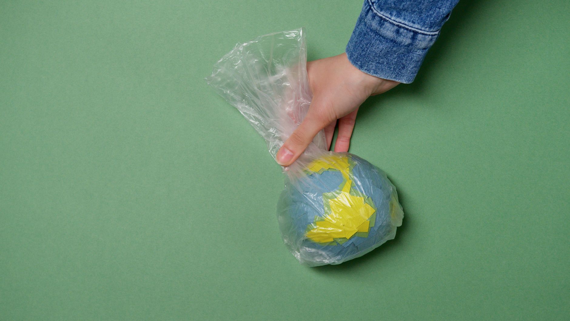 Conceptual image of Earth wrapped in plastic, symbolizing environmental issues.